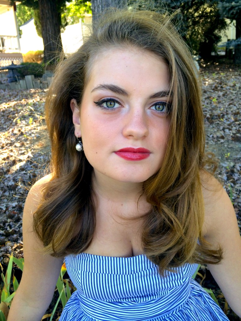 Audrey Hepburn style eyeliner with vintage pearl earrings.