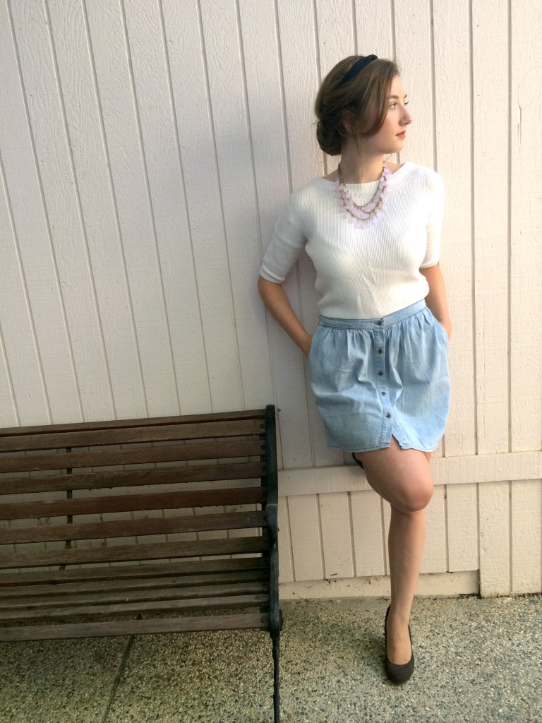 Updo hairstyle, white sweater, blue skirt, brown wedges, pink necklace