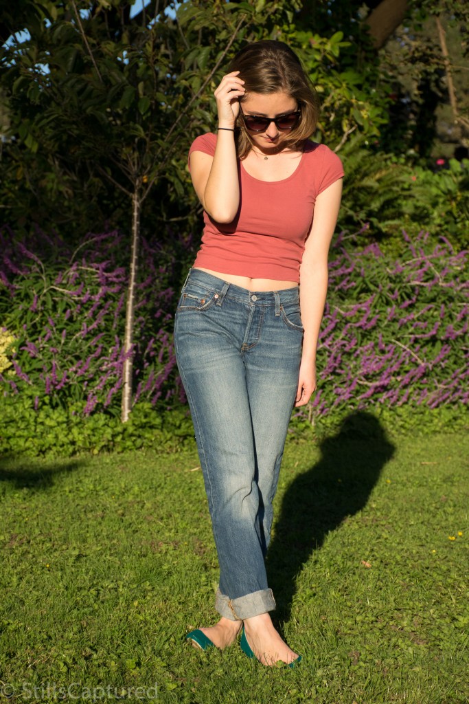 Peach crop top, high-waisted boyfriend jeans, blue flats