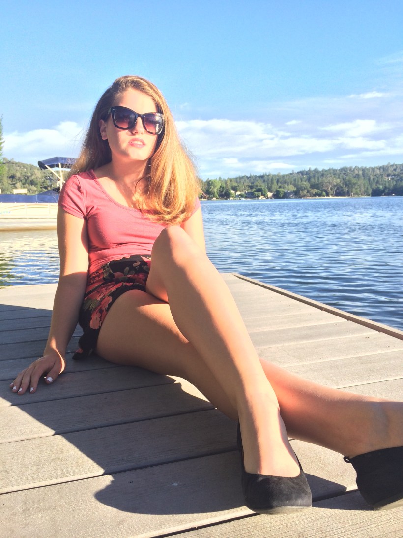 Peach crop top, floral print cloth shorts, black flats, oversized sunnies