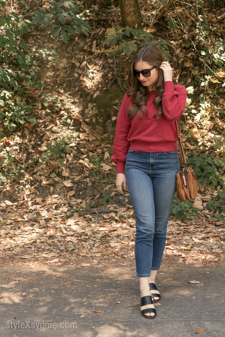 red sweatshirt, high waisted jeans, heeled slides, cross body purse
