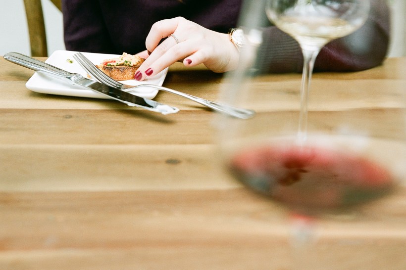 woman eating bread and cheese with wine, picture